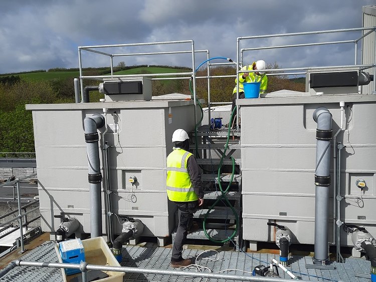 Engineers cleaning and disinfecting water storage tanks