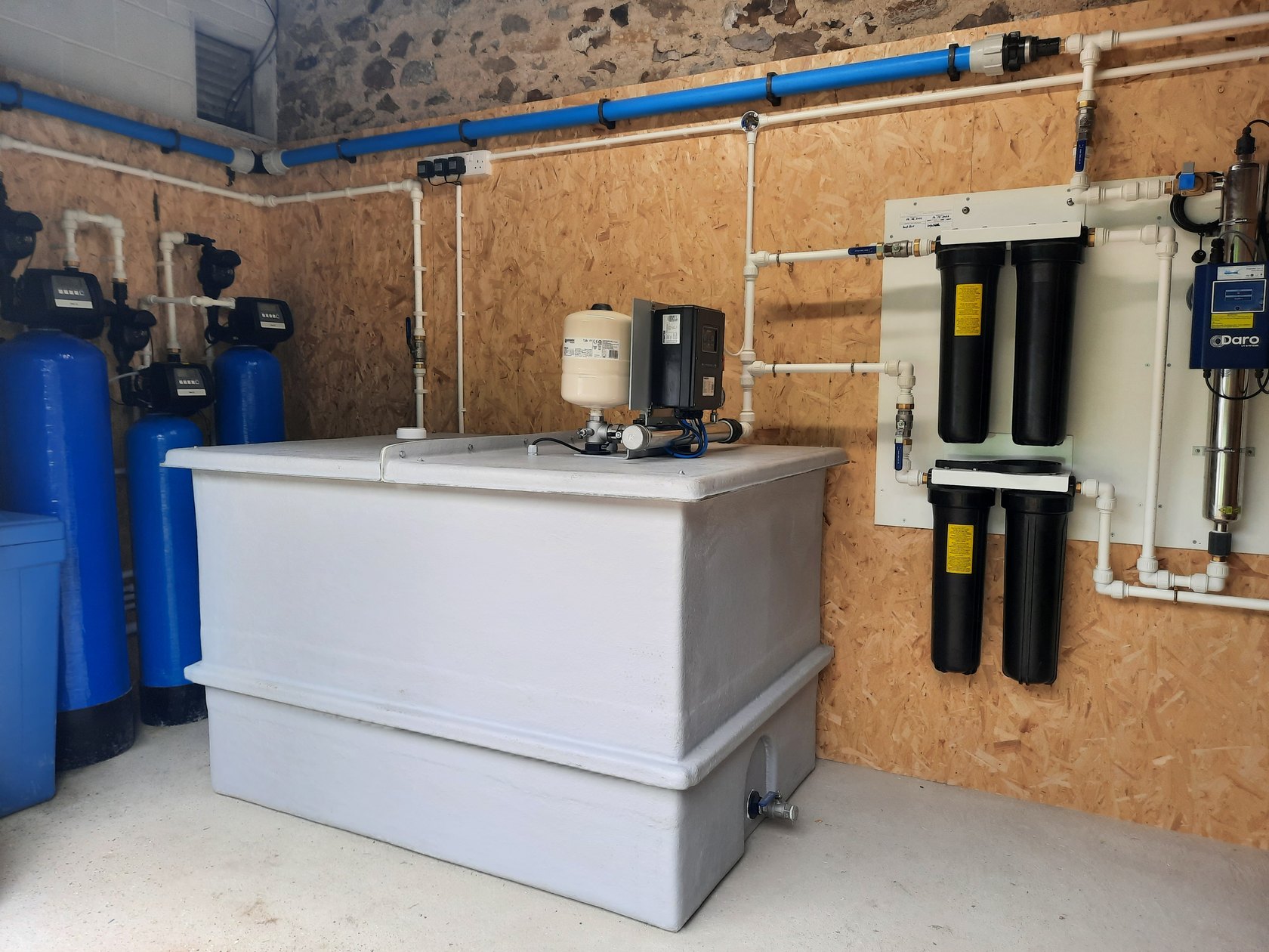 Storage tank, softeners and filtration in a private water plant room