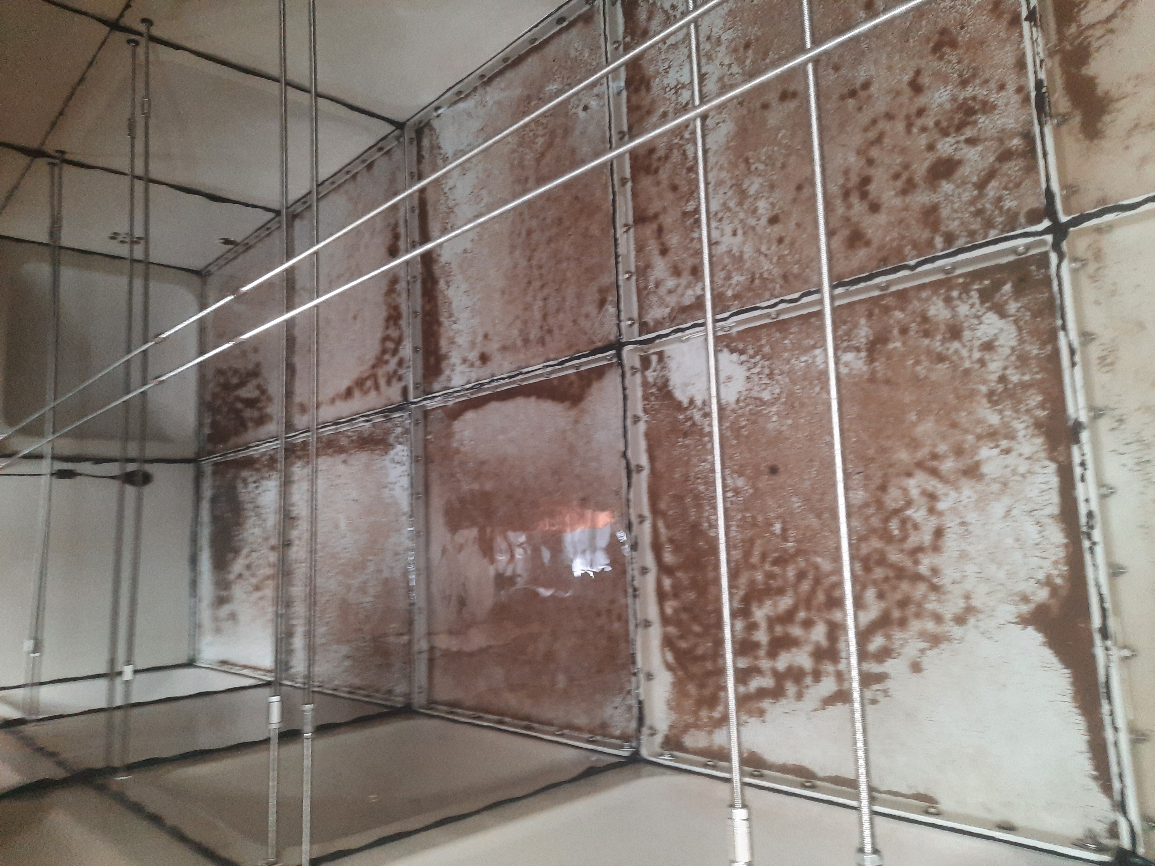 Tank interior before disinfection — heavy contamination and deposits